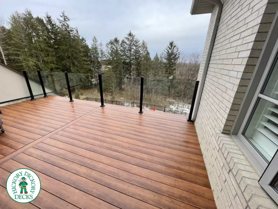 High brown composite deck with glass railings