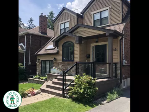 Brown porch with angled steps with lighting.
