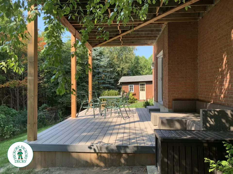 Balcony and deck both in grey Fiberon, with black aluminum railing on balcony.