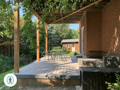 Balcony and deck both in grey Fiberon, with black aluminum railing on balcony.