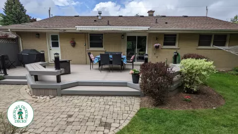 Low to ground grey deck with custom benches