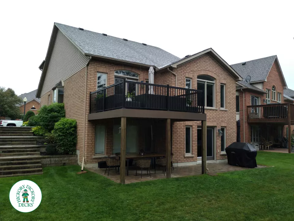 High brown azek deck with black railing.