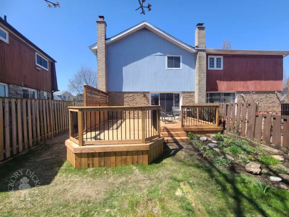 Low cedar deck with picket cedar railings and a cedar privacy screen.