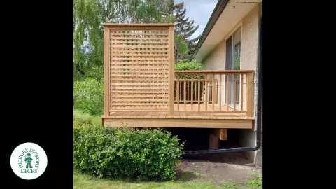 Small pressure treated deck with pressure treated privacy screens and railing.