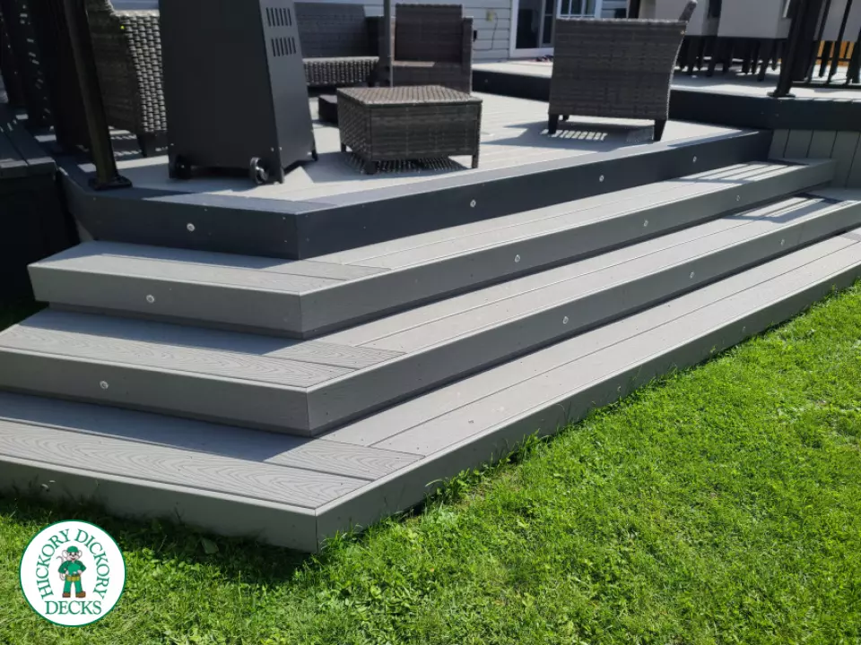 Trex deck in grey color with wrap around stairs, lights in steps.