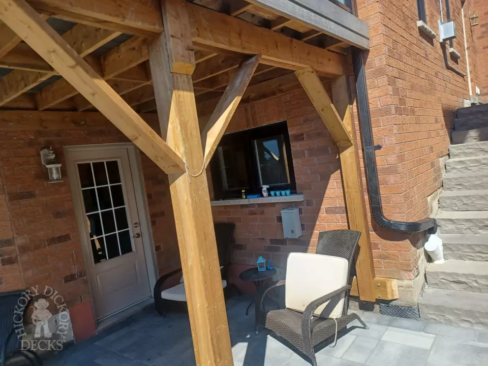 Large multi level grey composite deck with cedar skirt and black aluminum railing.