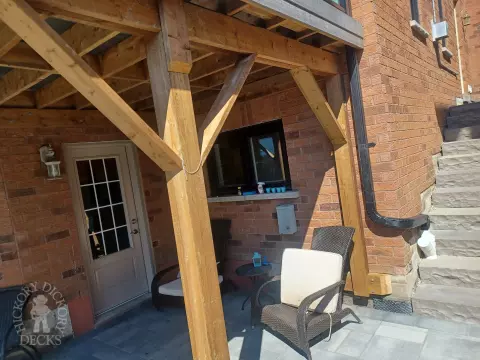 Large multi level grey composite deck with cedar skirt and black aluminum railing.