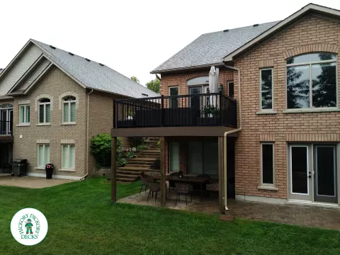 High brown azek deck with black railing.