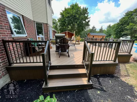 Clubhouse deck with aluminum railing with gate insert for access.