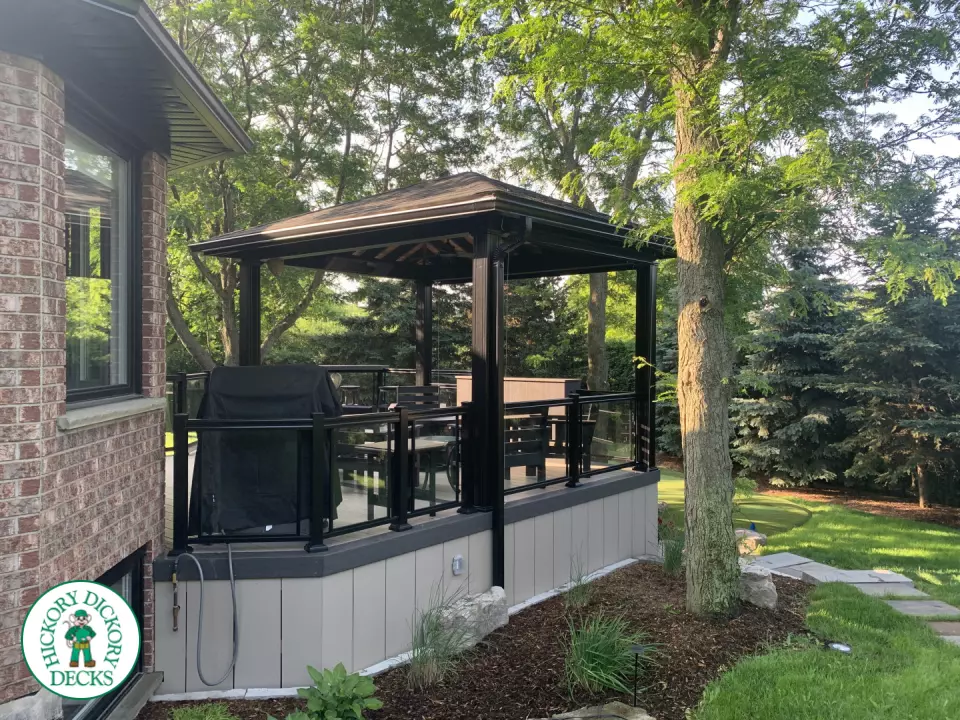 Clubhouse deck in cobblestone with a pavilion, glass railings, lights and a bar seating area, Flamborough, Ontario