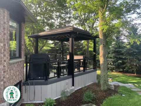 Clubhouse deck in cobblestone with a pavilion, glass railings, lights and a bar seating area, Flamborough, Ontario