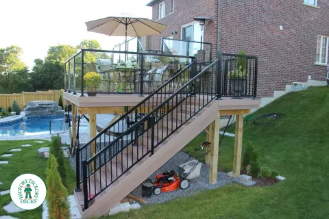 Trunorth high deck in light brown with glass railings.