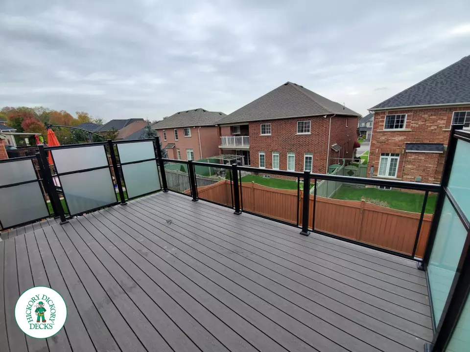 Clubhouse high deck with glass railings and privacy screens in Oshawa