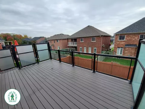Clubhouse high deck with glass railings and privacy screens in Oshawa