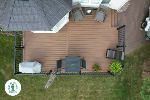 LArge brown fiberon deck with black aluminum railings.