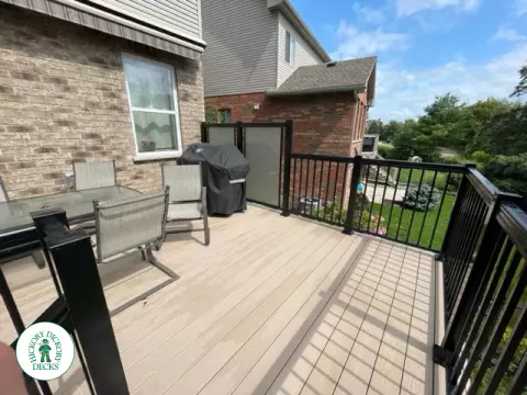 High rise Azek deck in beige color with unique steps and black railing.