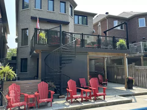 Clubhouse high deck with glass rail and spiral staircase in Newmarket