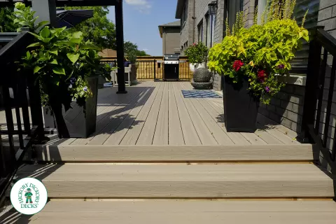 Large grey Fiberon walk out deck with black aluminum railings in Ancaster