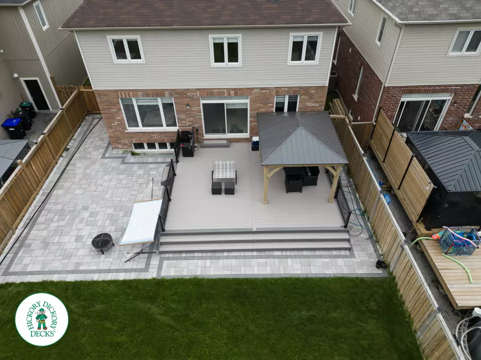 3 steps leading to a large Azek deck with lighting in the steps, and black aluminum railings.