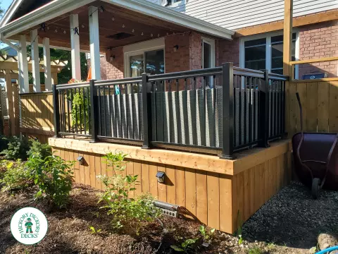 Cedar deck with roof structure that has a built in bar, and aluminum railings with a gate insert.