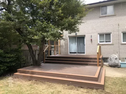 TruNorth deck with Mocha Caramel trim, wraparound steps, lights and a pergola, built around a tree. Etobicoke, Ontario