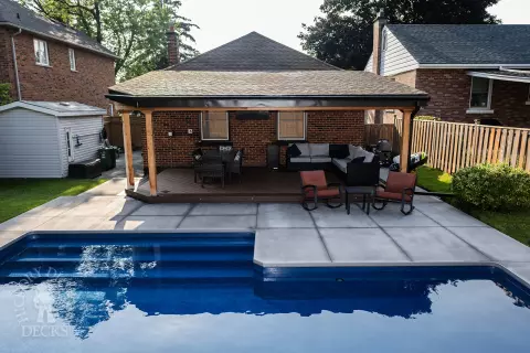 Small low brown composite deck with a dark brown border. and a custom roof structure.