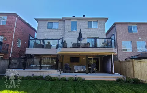 Azek high deck with glass railings and spiral stairs in Brampton