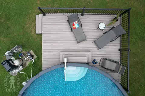 Small grey fiberon deck built around an above ground pool.