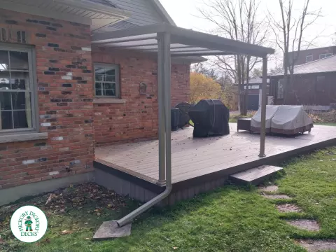 Grey deck with dark grey trim and a sunspace roof structure.