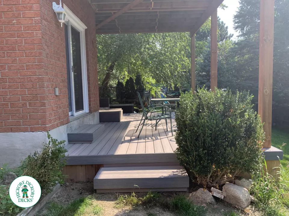Balcony and deck both in grey Fiberon, with black aluminum railing on balcony.
