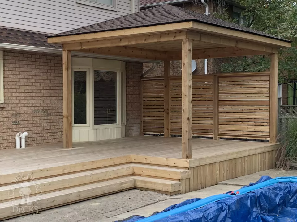 Cedar deck with privacy screens and pavilion in Oakville