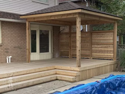 Cedar deck with privacy screens and pavilion in Oakville