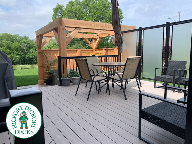 Slate grey Azek deck with large privacy screens, a pergola and aluminum rails, Kitchener, Ontario