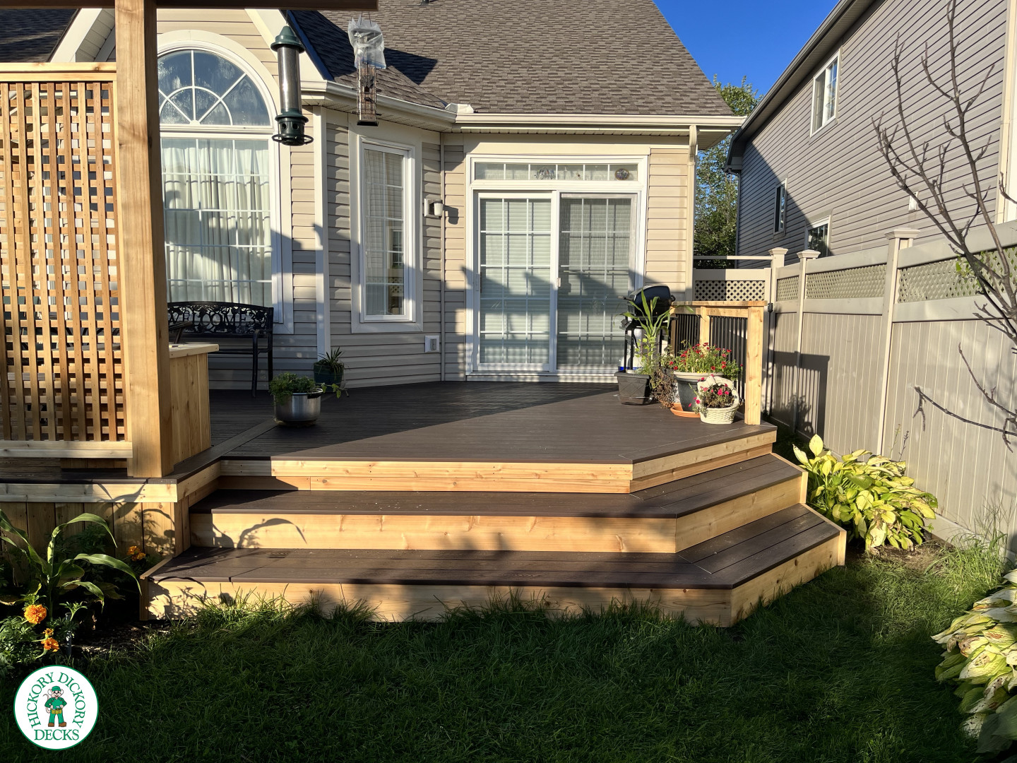 Mid size clubhouse deck in brown with cedar skirt, benches, planters, and a pergola.