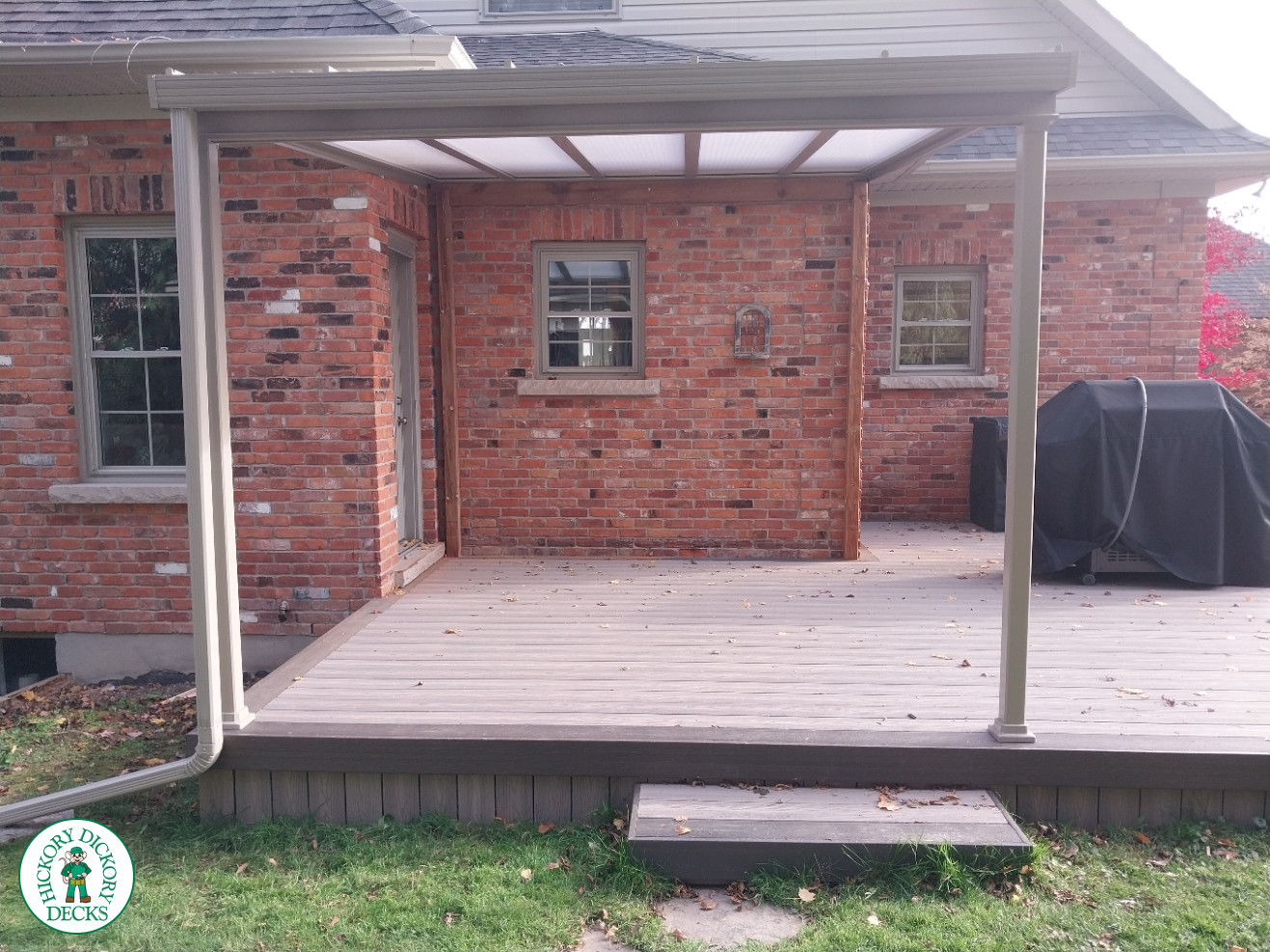 Grey deck with dark grey trim and a sunspace roof structure.