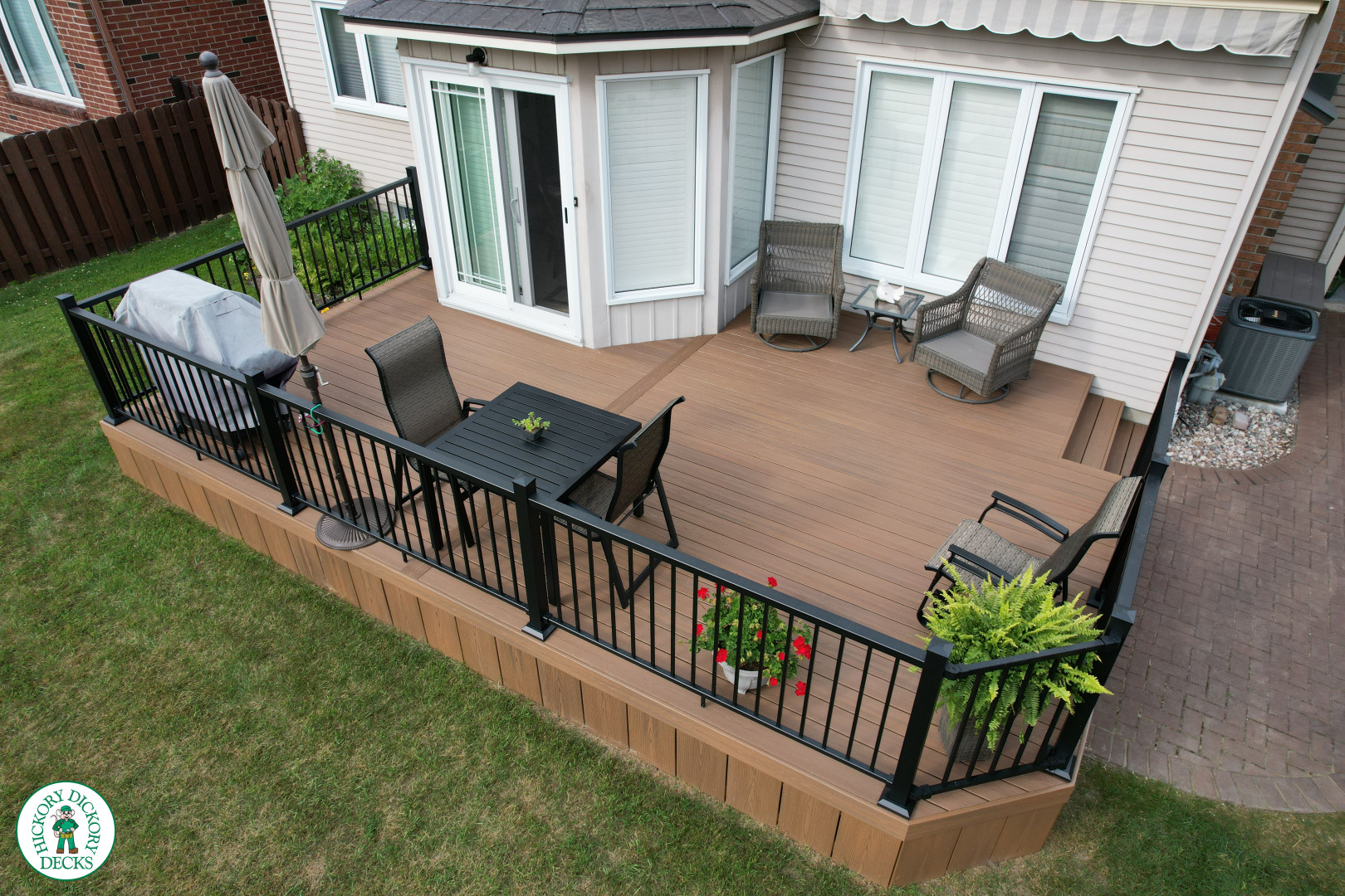 LArge brown fiberon deck with black aluminum railings.