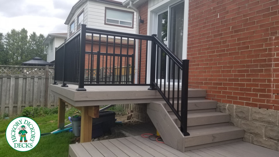 2 level Trunorth composite deck with steps to walk up deck, and wrap around stairs on the bottom level.
