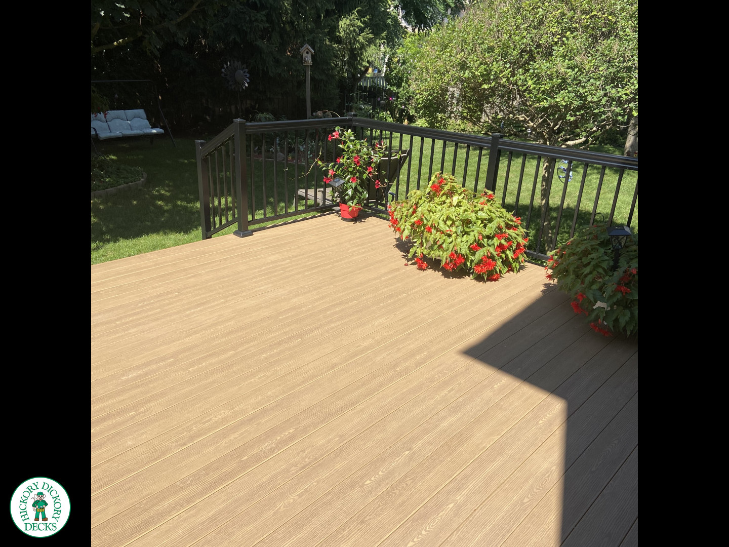 3 steps leading to small brown clubhouse deck with black aluminum railing.