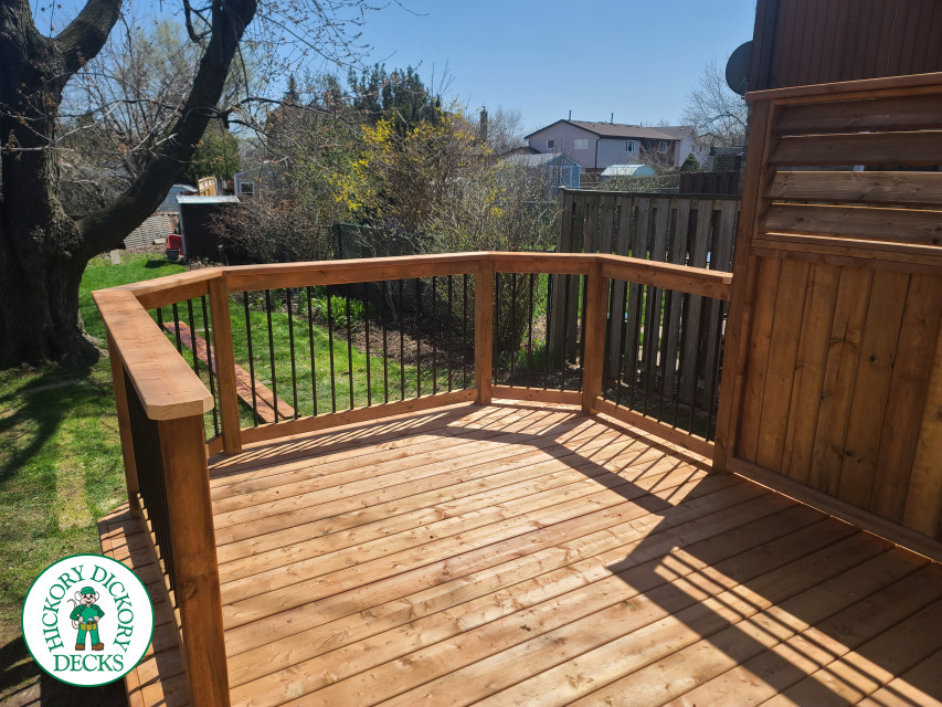 Low cedar deck with picket cedar railings and a cedar privacy screen.