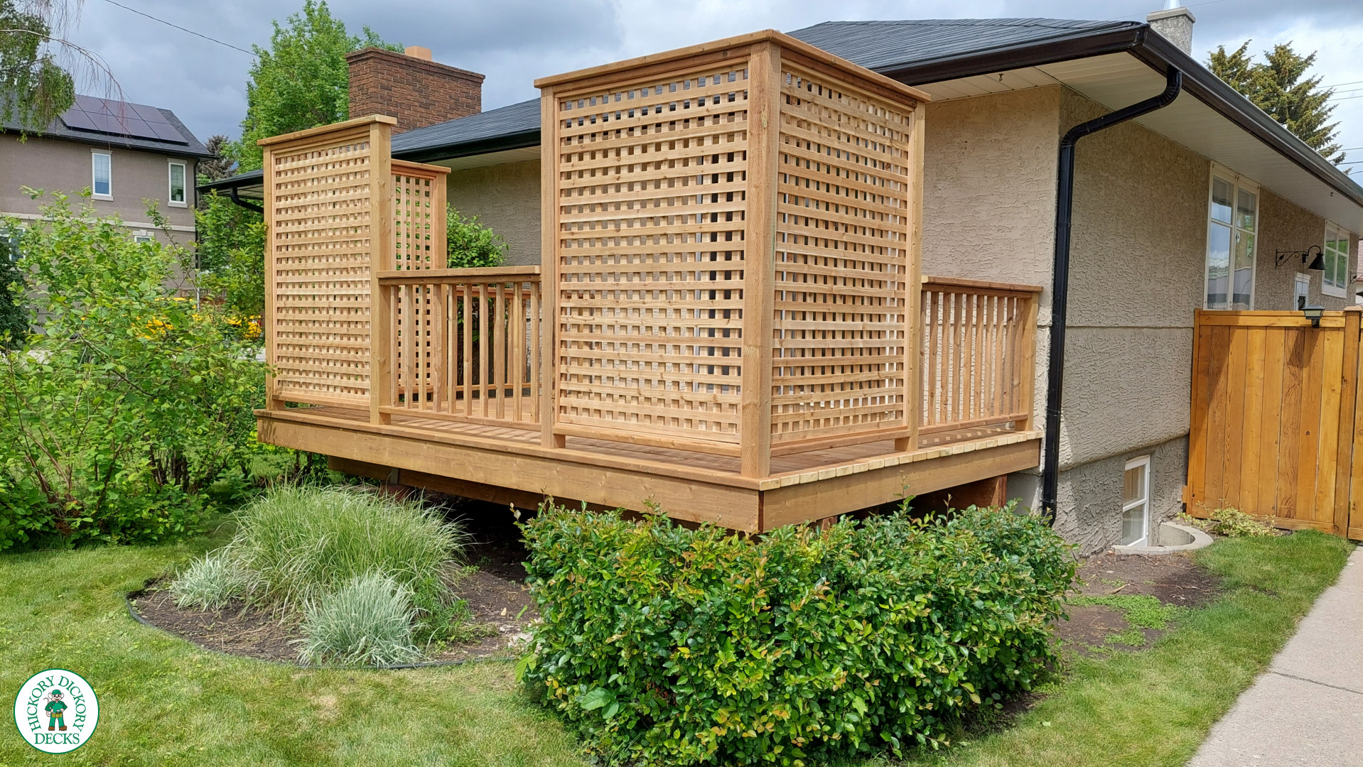 Small pressure treated deck with pressure treated privacy screens and railing.