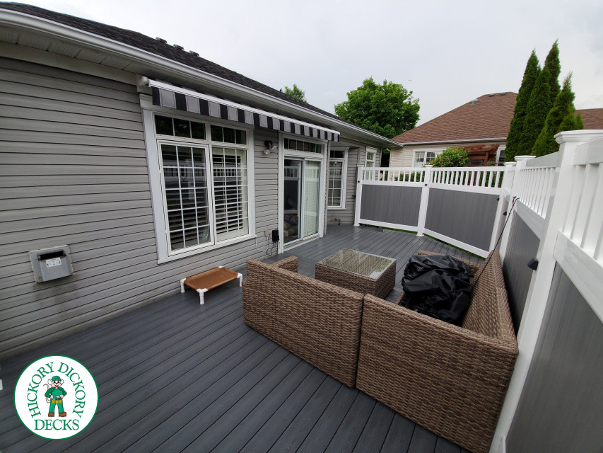 Private grey walk out deck with grey privacy screen all around