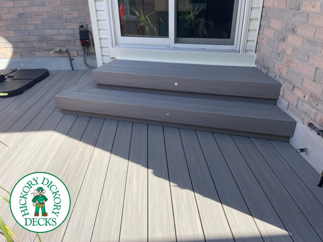 Small grey azek walk out deck with lighting in stairs