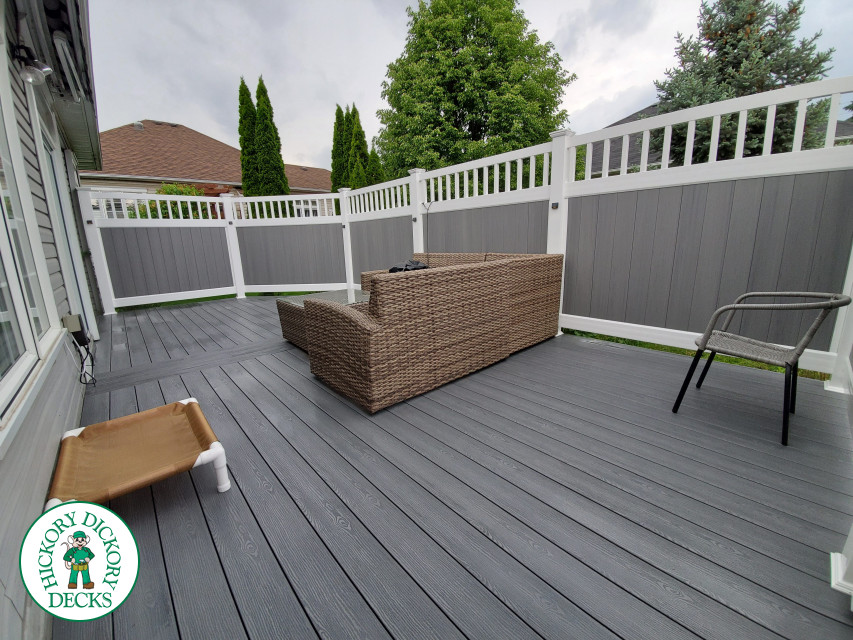 Private grey walk out deck with grey privacy screen all around