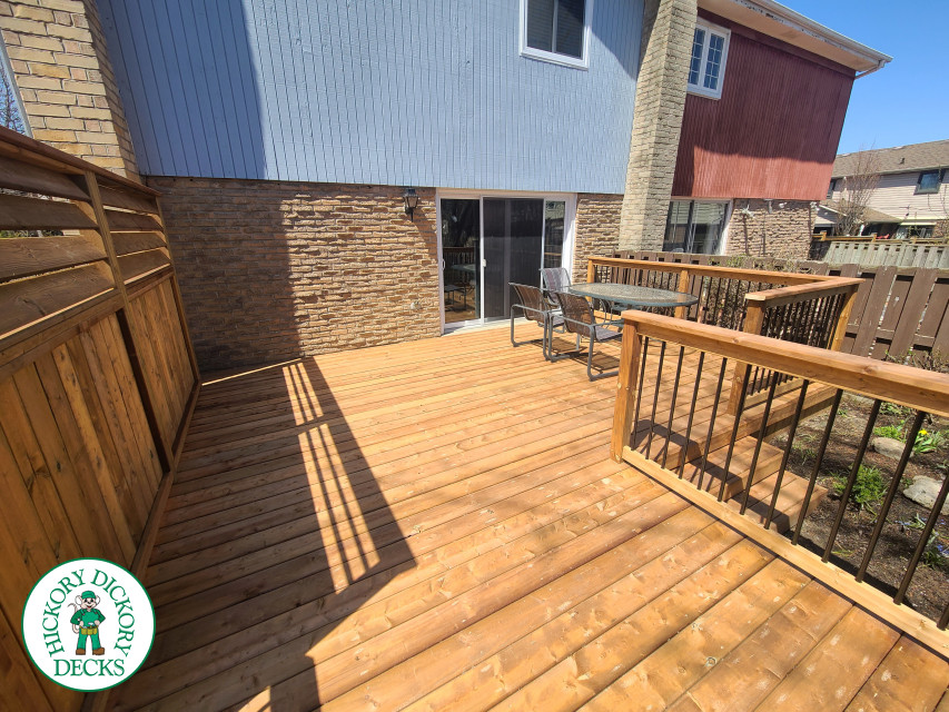 Low cedar deck with picket cedar railings and a cedar privacy screen.