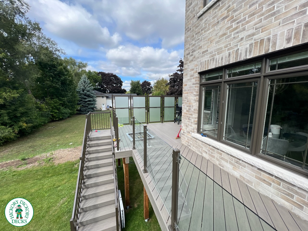 High grey composite deck with glass style railings.