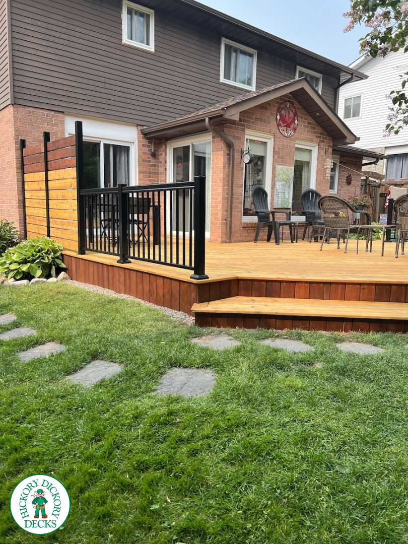 Large cedar deck with stairs, aluminum railing, and a cedar privacy screen.