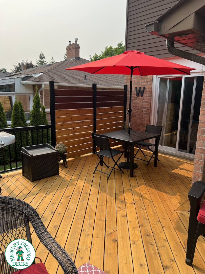 Large cedar deck with stairs, aluminum railing, and a cedar privacy screen.