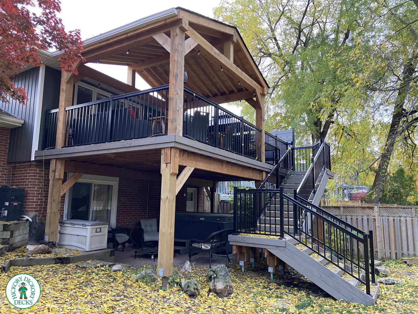 Mid-high deck brown TruNorth deck with lighting in steps and black aluminum railing all around.