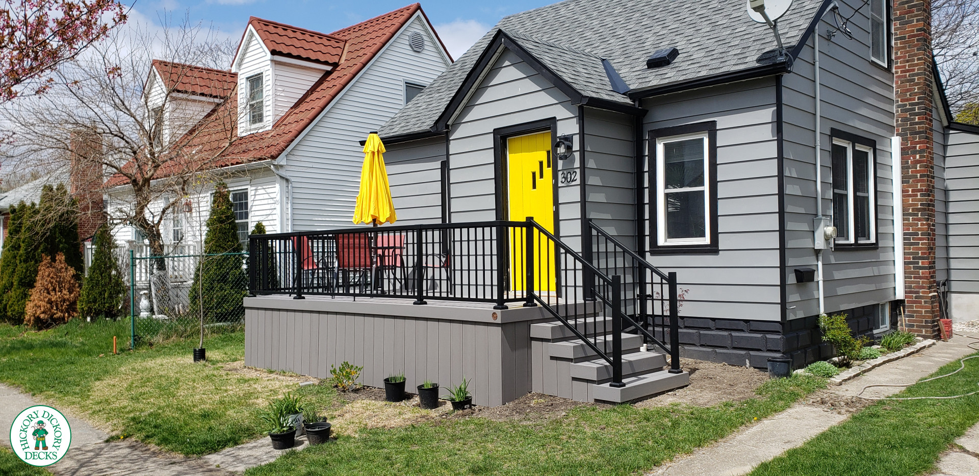 Small grey composite deck with black aluminum railing