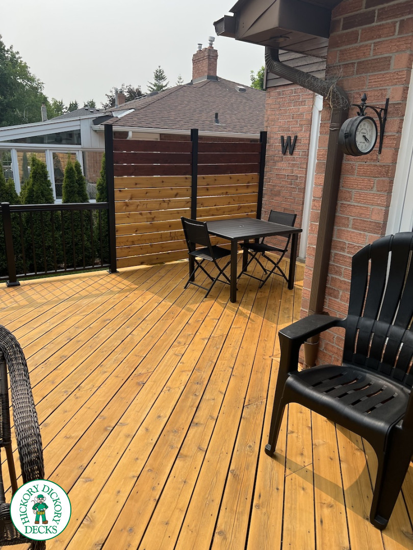 Large cedar deck with stairs, aluminum railing, and a cedar privacy screen.